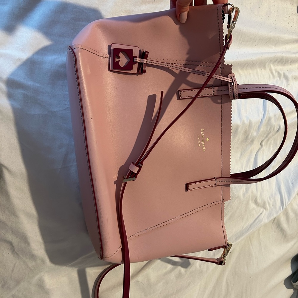 Kate spade crossbody pink purse with dark pink accents.